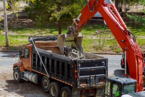 Construction waste removal using excavator